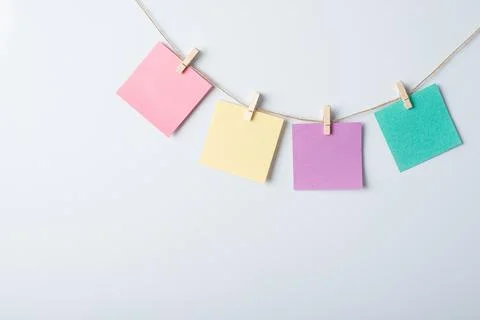 Four papers of different colour on a rope Stock Photos