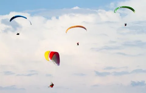 Four para-gliders against the clouds Stock Photos