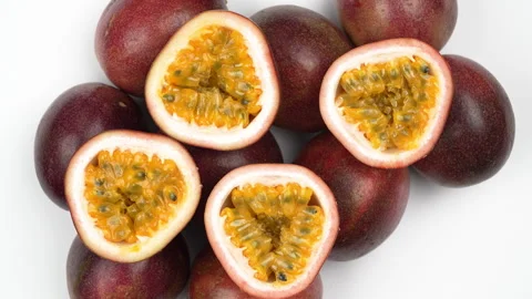 Four Passion Fruit Halves On Rotating Pile Of Whole Fruits White Background Stock Footage 323585227