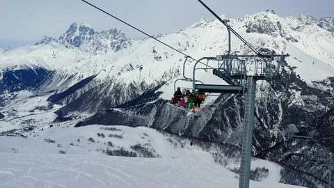 Four people are using the ski elevator to get up the mountain, amazing huge Stock Footage 105779346