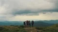The four people with backpacks standing on the beautiful mountain 4k or 4k+ Resolution