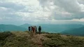 The four people with backpacks standing on a mountain 4k or 4k+ Resolution