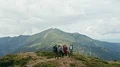 The four people with backpacks standing on the mountain 4k or 4k+ Resolution