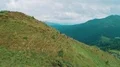 The four people with backpacks walking up on the mountain 4k or 4k+ Resolution