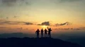 The four people dancing on the mountain against the beautiful sunset 4k or 4k+ Resolution