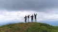 The four people dancing on the mountain with a picturesque landscape 4k or 4k+ Resolution
