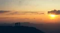 The four people dancing on a mountain top against the picturesque sunset 4k or 4k+ Resolution