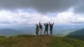 The four people jumping on the mountain with a beautiful landscape 4k or 4k+ Resolution
