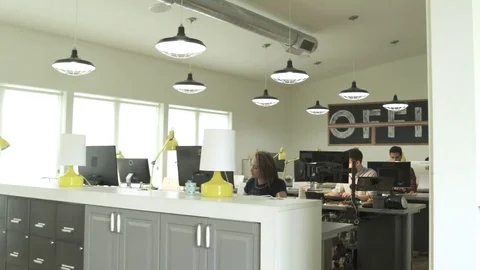 Four people looking at camera while working in an office 스톡 동영상 83396519