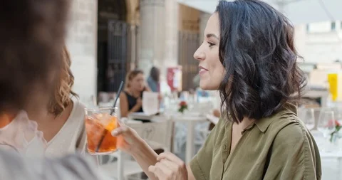 Four people or two couples happy toasting with cocktail at aperitif in city cafe 動画素材 107633565