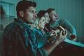 The four people with a pizza watch a movie on the sofa Photo
