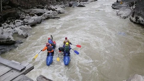 The four people is running down the fast wild river on the twin-hull boat. Stock Footage 90364146