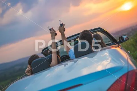 The four people sit in the cabriolet Stock Photos