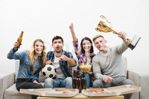 The four people on the sofa watch a football on the white background Stock Photos
