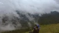 The four people standing on a cliff of a mountain with beautiful cloud view 4k or 4k+ Resolution