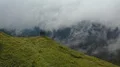 The four people standing on a cliff of the mountain with a beautiful cloud view 4k or 4k+ Resolution