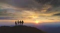 The four people standing on the mountain against the beautiful sunrise 4k or 4k+ Resolution