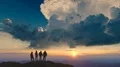 The four people standing on a mountain against the beautiful sunrise 4k or 4k+ Resolution
