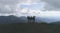 The four people standing on a mountain with a picturesque view 4k or 4k+ Resolution