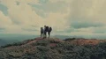 The four people standing on the mountain with a picturesque landscape 4k or 4k+ Resolution