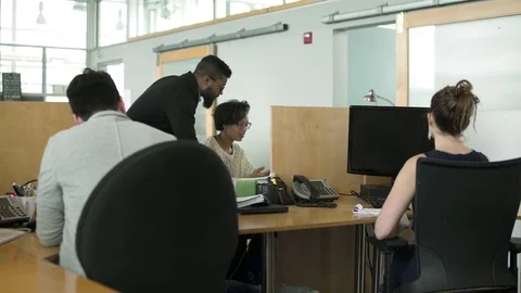 Four people working in an office 動画素材 77093923