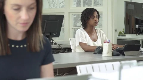 Four people working in an office Stock Footage 83396174