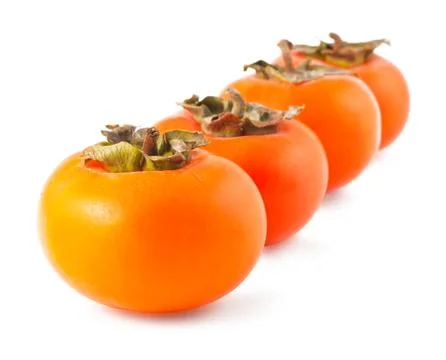 Four persimmons Stock Photos