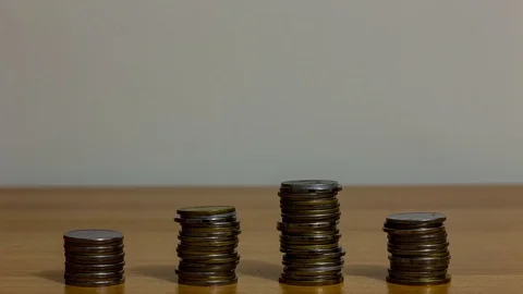 Four piles of coins Stock Footage 100552424