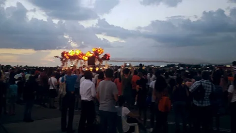 Four plane formation passing through pyrotechnic display in front of crowd Stock Footage 96215281