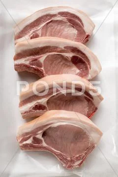 Four pork chops Stock Photos