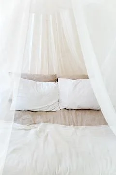 Four-poster bed with two pillows. Scandinavian simplicity design. Eco loft ap Stock Photos