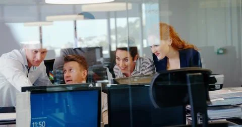 Four professionals are collaborating around monitors in flat design business Stock Photos