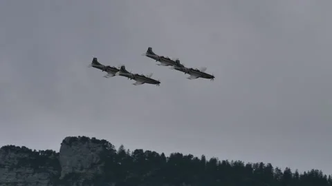 Four propeller planes perform a precise and synchronized barrel roll Stock Footage 147616260