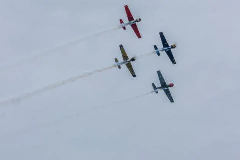 Four propeller stunt planes flying formation smoke trails airshow Gijon Spain 스톡 사진