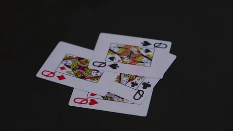 Four queen poker cards falling on the black table Video stock 77041874