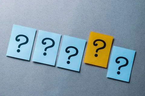 Four question marks on blue and one on yellow Foto stock