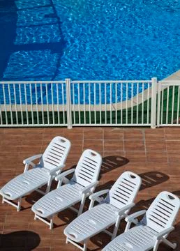 Four recliners in the pool Stock Photos