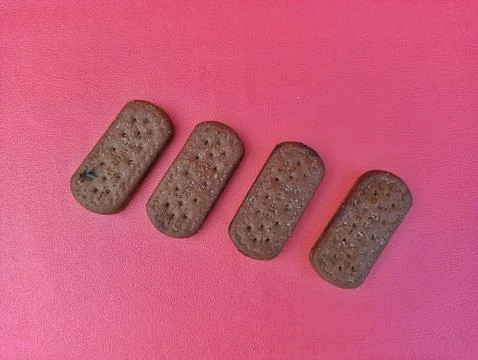 Four Rectangular Chocolate Cookies with Sprinkles on Pink Background Stock Photos