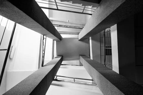 Four rectangular columns, staircases with metal chrome railing, bright light  Foto stock