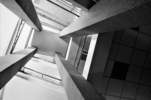 Four rectangular columns, staircases with metal chrome railing, bright light  Foto stock