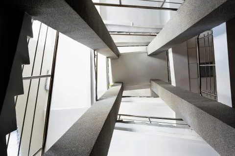 Four rectangular columns, staircases with metal chrome railing, abstract pers Foto stock