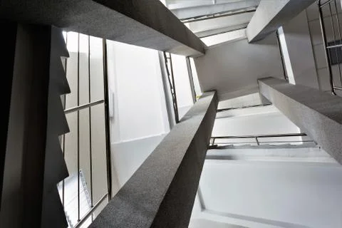 Four rectangular columns, staircases with metal chrome railing, abstract pers Foto stock