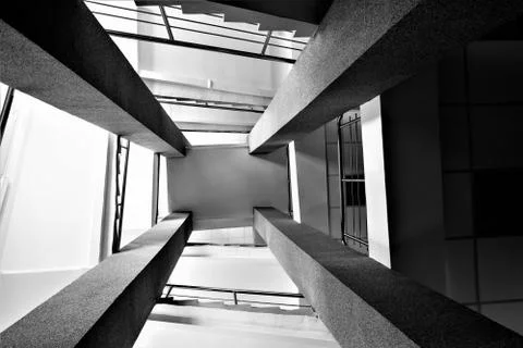 Four rectangular columns, staircases with metal chrome railing, abstract pers Foto stock