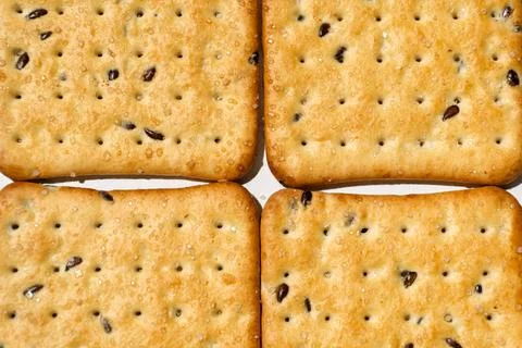 Four rectangular golden crackers with sugar crystals and dark flax seeds Stock Photos