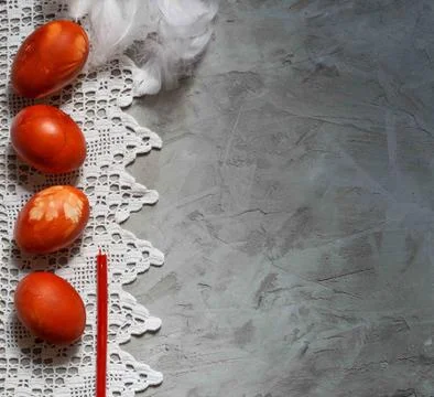 Four red easter eggs on a lacy napkin on a gray background, horizontal orient Stock Photos