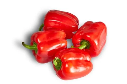 Four red pepper lie on a table Stock Photos