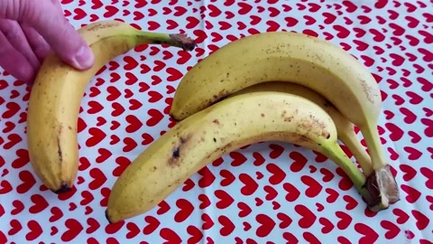 Four Ripe Bananas on Heart - Patterned Red and White Tablecloth Video stock 327520112