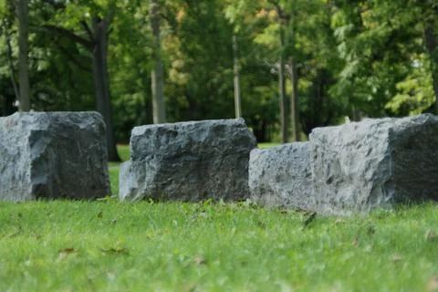 Four Rocks On Grass Stock Photos