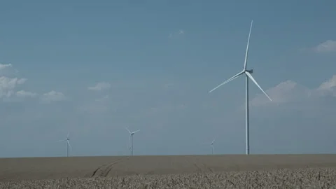 Four rotating wind turbines in a field of wheat Stock Footage 246072600