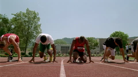Four runners leaving the starting blocks, viewed at ground level in slow motion Stock Footage 59533745